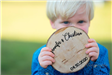 Child Holding Wooden Wedding Invitation - RL Photography